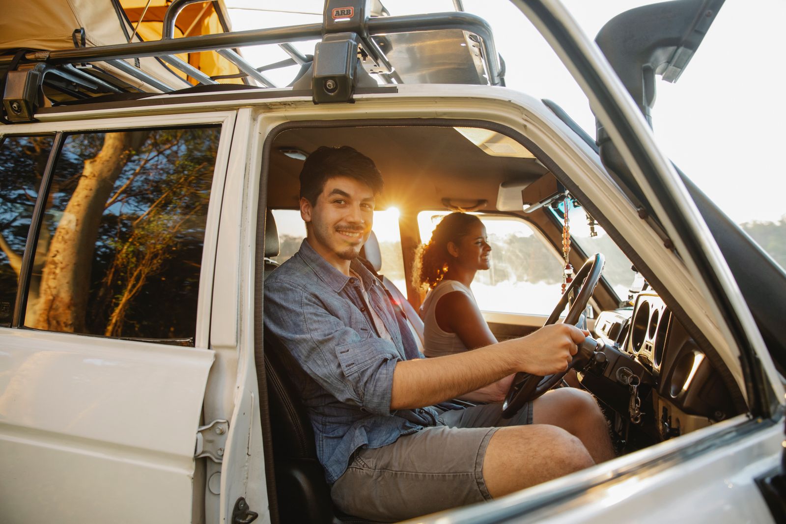 Friends laughing in their car on a road trip